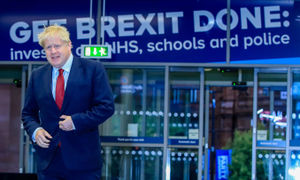 Prime Minister Boris Johnson enters the hall to do morning interviews at the Conservative Party Conference in Manchester