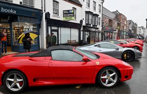 Visitors to the Bridgnorth Italian Moto Fest brave the horrendous downpours to view the cars on show.Ferraris line the High Street