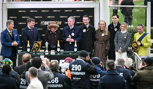 Queen Camilla presents the trophies for the Queen Mother Champion Chase to trainer and owner Barry Connell (4th L) of Marine Nationale and Jockey Sean Flanagan (R) on Wednesday (Photo by JUSTIN TALLIS / AFP) (Photo by JUSTIN TALLIS/AFP via Getty Images)          