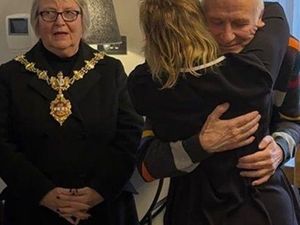 Yvonne hugs her husband Tony as Dudley mayor Cllr Hilary Bils pays tribute to Tony for the help and support provided to Yvonne over the years 