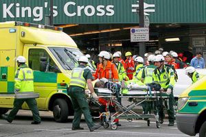 A casualty is taken away on a stretcher at London's King Cross station after explosions rocked the Underground system
