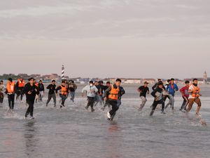 Supporting image for story: Migrants run across beach to board dinghy in the Channel