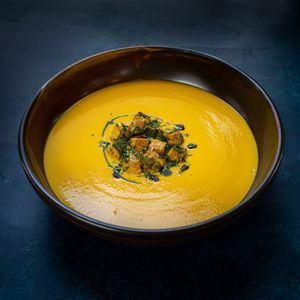 Carrot and ginger soup with parmesan croutons and pasley