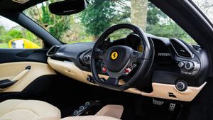 The cream leather interior is a classic choice in a Ferrari