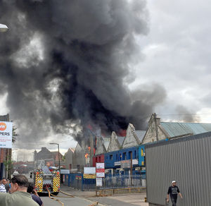 There were fears the blaze would spread to a nearby fireworks wholesaler, the blue building pictured here