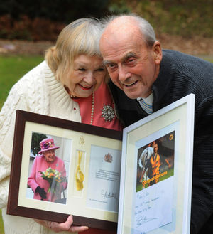 Jean Spence and husband Ken Spence with a card from The Queen and a special signed picture from Wolves legend Steve Bull 
