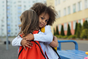 2 young children hugging