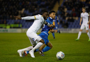 Mo Eisa of Peterborough United and Josh Laurent of Shrewsbury Town.