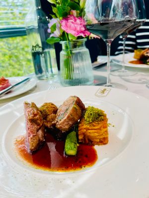 Two bone lamb rack, served with neck croquette, pea pureé, British asparagus, pine nut crumb and Pedro Ximenez sauce