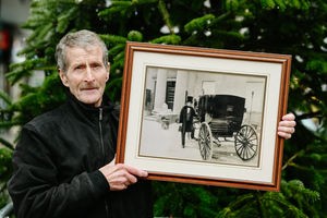 Kim holding a a picture of himself outside of the old Royal Salop Infirmary.