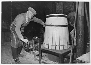 Thomas Trevis Smith Ltd., barrel making, Cradley Heath. Joseph Gill firing the barrel after one end had been shaped and hooped. March 13, 1974.