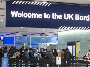 Passengers line up for passport control at Heathrow Airport