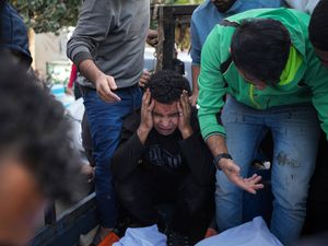 Palestinians mourn their relatives