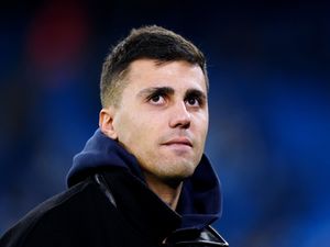 Rodri looks on from the sidelines