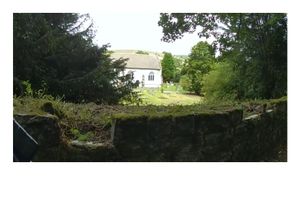 Several stones have been removed from the roadside wall which forms the boundary of the graveyard
