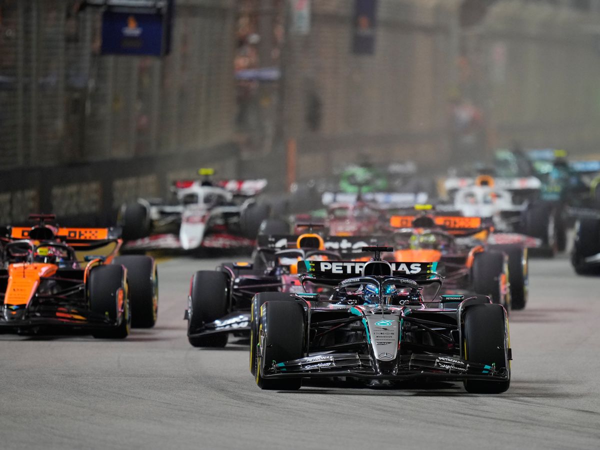 McLaren duo collide on opening lap before George Russell wins Singapore GP