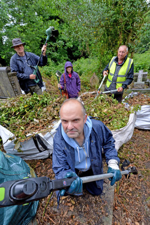 Paul Rhodes, front, with volunteers from the Friends of All Saints' Graveyard