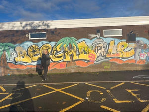 Councillor Tina Jukes surveys the graffiti daubed on the Beechdale mural