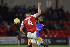 A clash between Chuks Aneke of Shrewsbury Town and James Bolton of Fleetwood Town saw the latter sent off