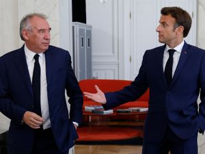 Francois Bayou and Emmanuel Macron talking