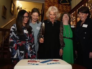 Camilla cutting cake