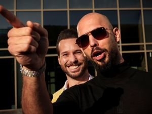 Andrew Tate gestures, next to his brother, Tristan