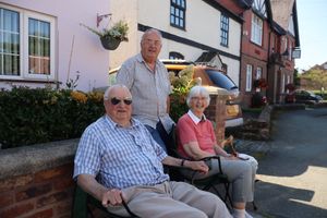 Barry, Neil and Geraldine Woolham have seats in the shade to watch the tour