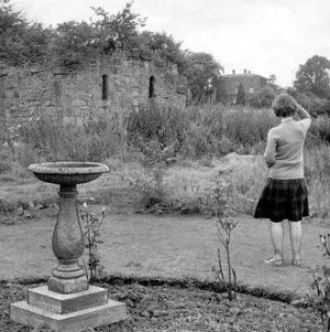 Malinsee chapel, pictured on August 15, 1962. The caption reads: 'Malinslee Hall, tucked among the trees, and in the foreground is the old abbey ruins. Legend has it that there is a secret passage connecting the two.' The young girl on the picture is the late Shropshire Star journalist, Shirley Tart. Both chapel and hall were destroyed during the building of Telford shopping centre. The chapel site lies directly beneath the main shopping precinct, and Malinslee Hall is more or less underneath the Woodhouse Central inner ring road to the north west of the chapel site. The chapel was taken down stone by stone and later rebuilt at Telford town park.