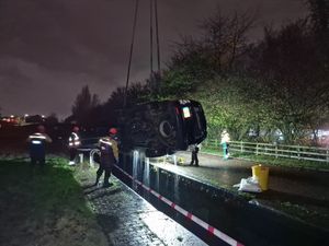 The car was craned out of the canal after dark. Photo: Lee Bates