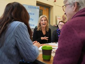 The Duchess of Edinburgh reacts as she sits around table during a discussion at the Mothers’ Union’s English for Women project in Chelmsford, Essex