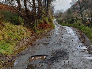 Supporting image for story: Tourist road packed with potholes