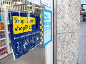 A 'Stop, Don't Shoplift' sign in the window of a Boots shop