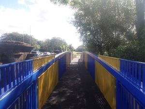 The Meole footbridge - and its blue and amber paint job - was lifted into place over the weekend.
