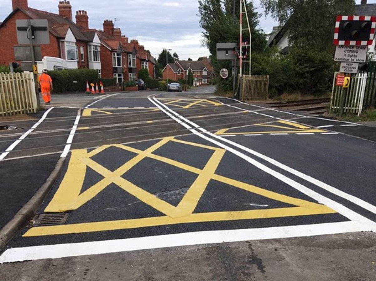 Car rolls on side near railway crossing