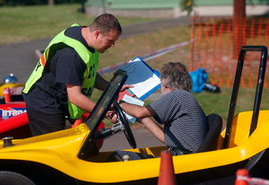 A timekeeper gives a driver his times after one of the tests