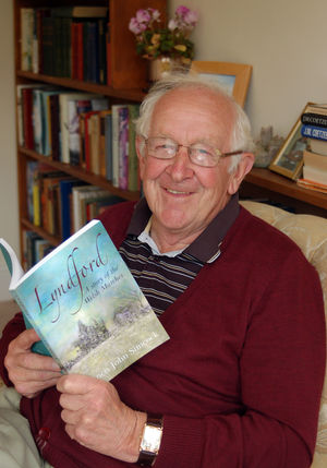 Wattlesborough pic. John Simcock with his book Lyndford, pictured at his home