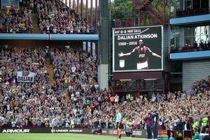 A tribute is shown on the big screen, as fans applaud on the 10th minute, in memory of former player Dalian Atkinson