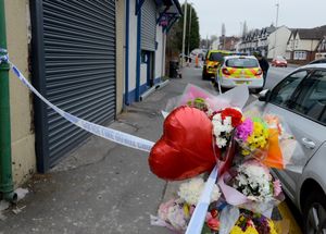Floral tributes left outside the flat where Mr Kang died