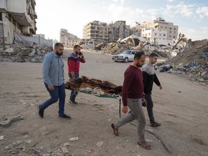 A body of a Palestinian killed in an Israeli army airstrikes is brought to Shifa Hospital in Gaza City