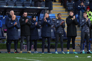 Matt Taylor the head coach of Shrewsbury Town observes a minute of applause. Credit: AMA