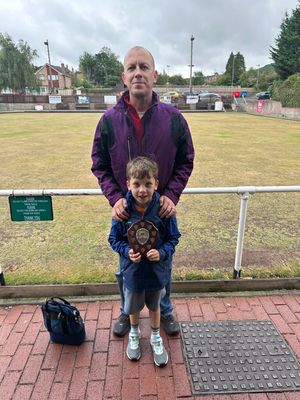 Consolation trophy time for Ian and Finley Pessall