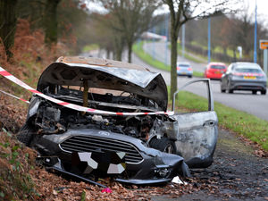 Supporting image for story: Car wreckage left at roadside after fire in West Bromwich