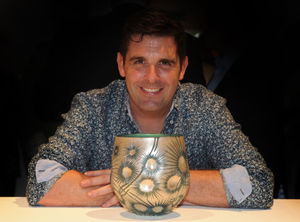 With a piece of his work, glass artist Allister Malcolm, of Penn, during the 2017 British Glass Biennale