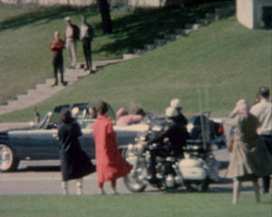 First Lady Jacqueline Kennedy cradles her husband President John F. Kennedy seconds after he was fatally shot.