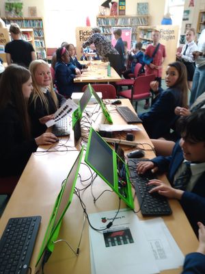 Pupils undertaking problem solving exercise on laptops