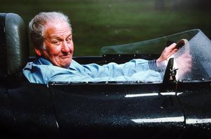 Norman Dewis at the wheel of a D-type