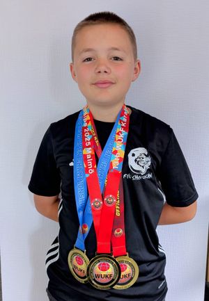 Zack with his world, British and Scottish champion medals 