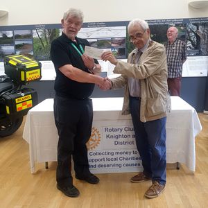 Colin Barnett from Wales Air Ambulance receiving a cheque from Knighton Rotary President Robert Wayne