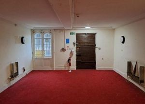 The original front doors, with musket damage from the siege following the Gunpowder Plot, viewed from inside the hall