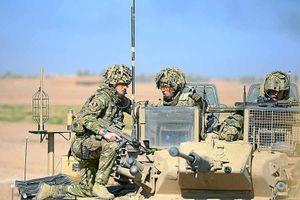 Major Andy MacLanahan talks tactics with comrades at the scene
